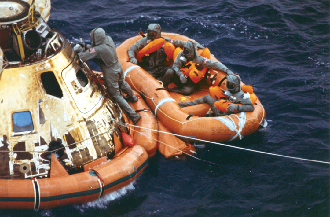 U.S. Navy Lt. Clancy Hatleberg, left, was the first human being that the Apollo 11 astronauts encountered after they returned to earth on July 24, 1969, after their historic moon landing. (Image: NASA on The Commons)