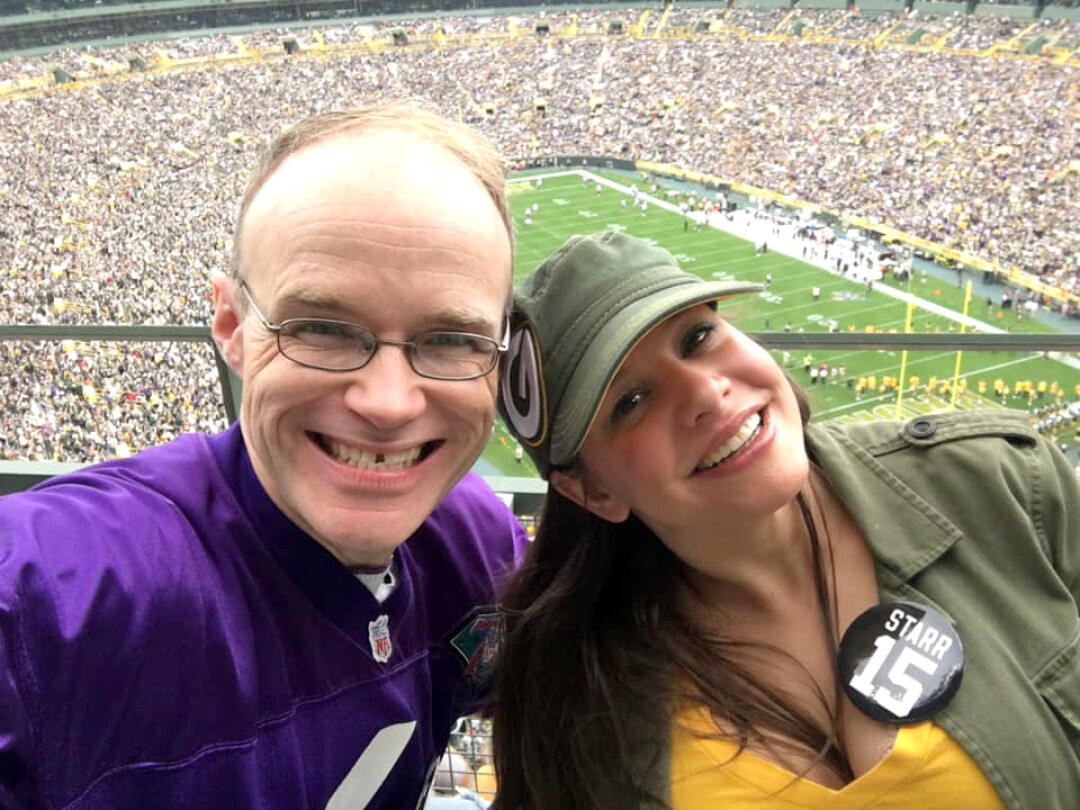 OPPOSITES ATTRACT. The writer and his wife prove that a Viking fan can survive a visit to Lambeau Field.