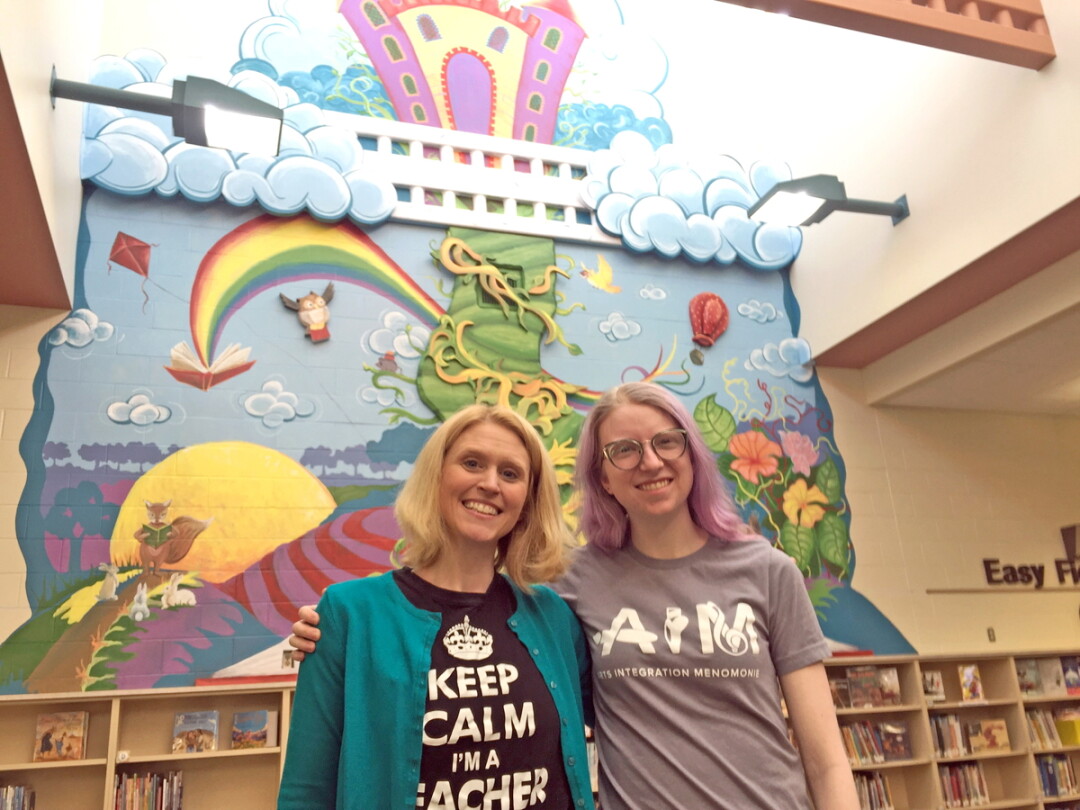 ART THAT POPS. Arts Integration Menomonie executive director Tami Weiss, left, and UW-Stout art student Taylor Gardner, at Oaklawn Elementary, the site of group’s new 3-D mural.
