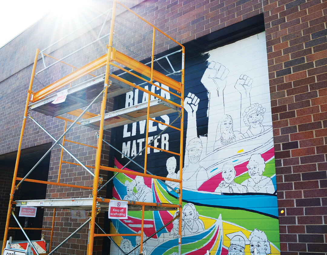 BLACK LIVES STILL MATTER. Yet another mural is in progress in downtown Eau Claire on The Lismore garage doors near the corner of Farwell St. and E. Grand Ave. The mural was designed, put together, and installed by local BIPOC artists to further the local conversation on race and police brutality.