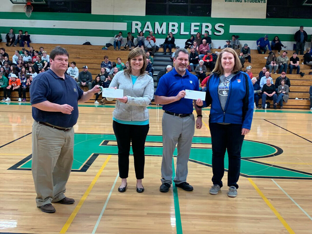 Supporting community organizations is part of NB's role as a community bank. Here, donations are made to the booster clubs of Regis and McDonnel 