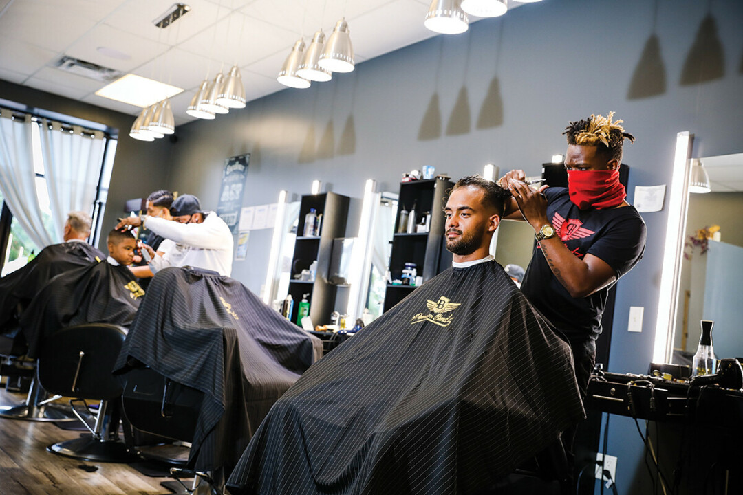 ROLL THE CLIP. Navontay Wilson, owner of Premium Blendz Barber Lounge (top right), starts off each day at 4am with a workout and some yoga. Then, he sets to work. 