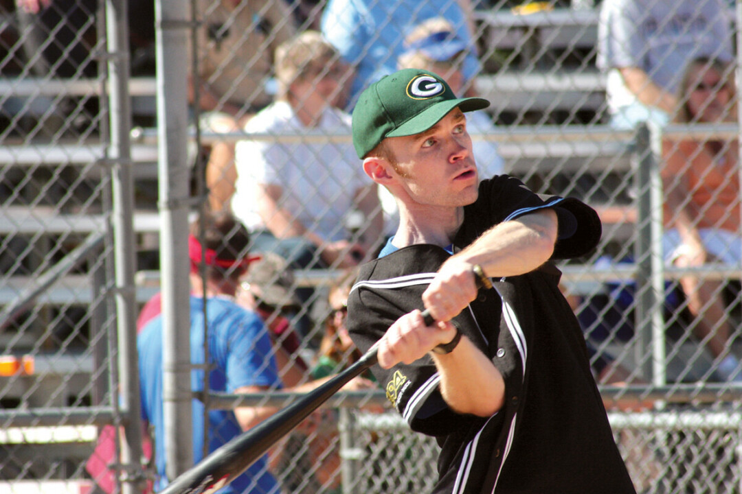 AIM FOR THE FENCES. The columnist makes a rare appearance in Packer apparel during a media softball game.