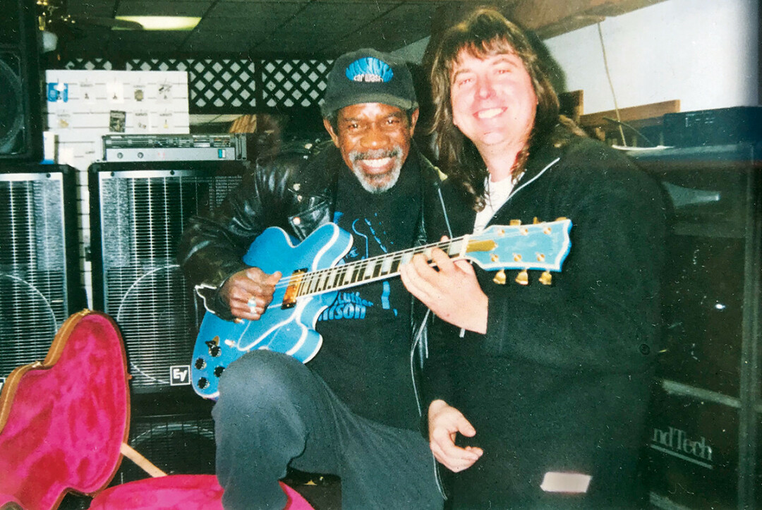 BITTERSWEET SYMPHONY. Mike Schlenker (right) with Luther Allison back in the day. “One of the all-time great blues players and a great dude,” Schlenker said. Schlenker’s long-running music gear and repair shop, Speed of Sound, closed earlier this summer.