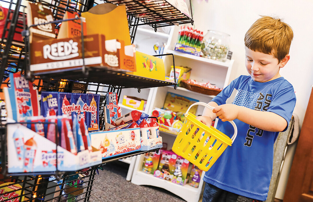 SHOP TIL YOU DROP. A young customer at C&J's Candy Store in Menomonie.