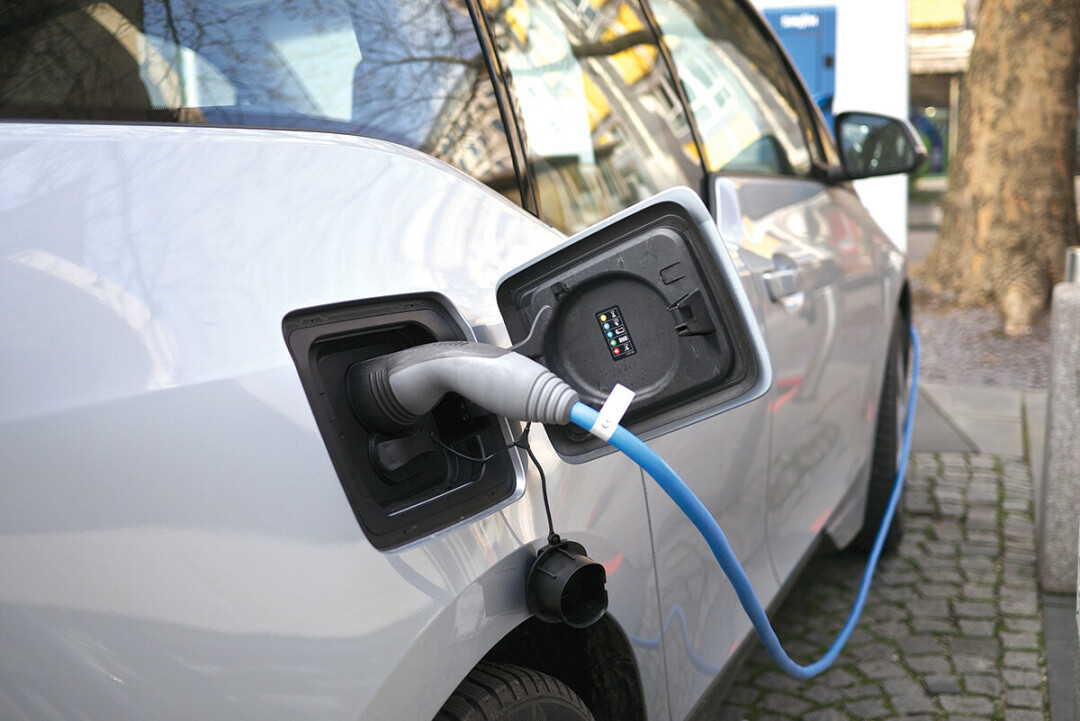 An electric car getting charged. (Photo by Name here | CC BY 2.0)