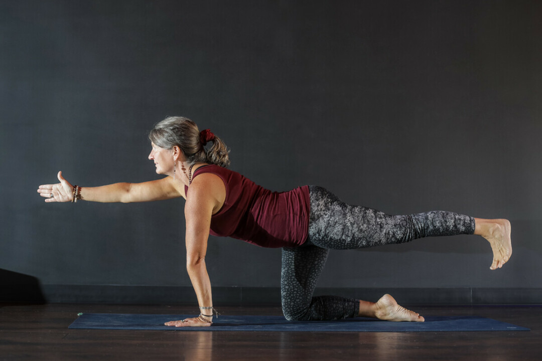 Lucinda Kemmet demonstrates yoga poses at The Yoga Room.