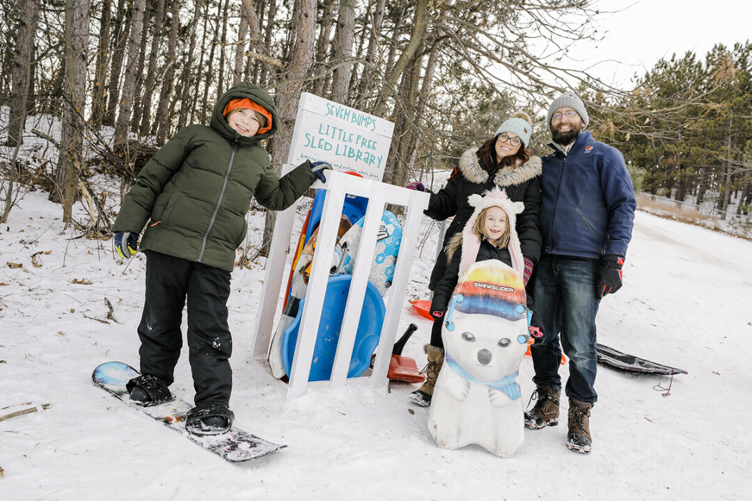 Owen, Molly, Michelle, and Chad Rowekamp are always looking for ways to improve Eau Claire's Eastside Hill Neighborhood, such as by creating this Little Free Sled Library at the food of the Seven Bumps Hill.