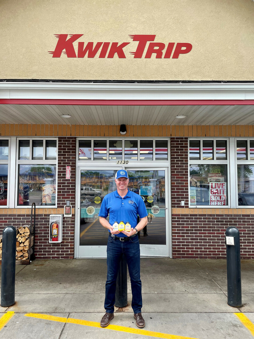 GET 'EM WHILE THEY'RE HOT. Silver Spring Foods President Eric Rygg showcases some of the company's products outside a Kwik Trip store, where they are now available. (Submitted photo)