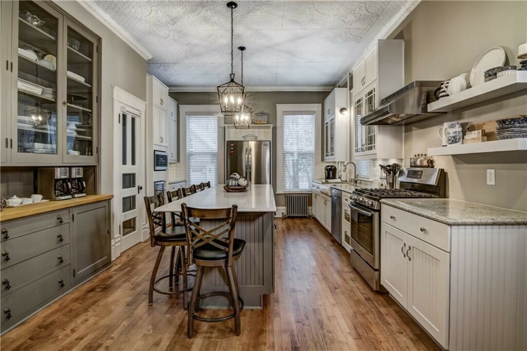 IT'S NOT ALL ANTIQUE. The kitchen includes a central island and quartz countertops.