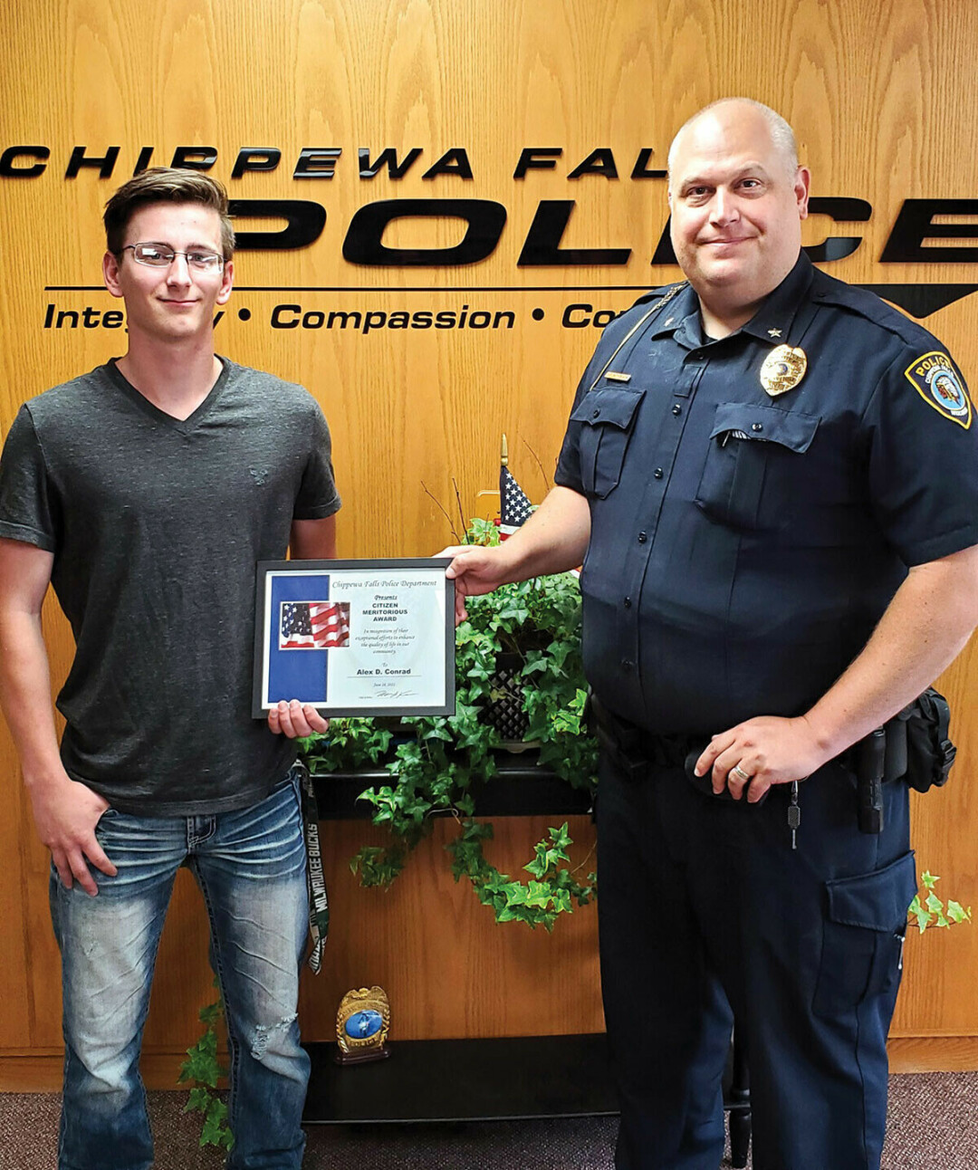 DO THE RIGHT THING. Alex Conrad, left, was honored by Chippewa Falls Police Chief Matthew Kelm. (Submitted photo)