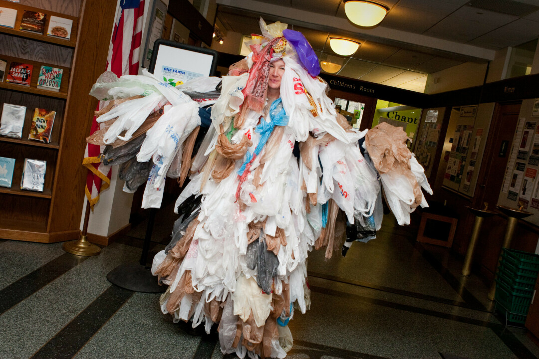 CAPTION: Julie Moller wears a “Bag Monster” costume, comprising 500 plastic shopping bags – which represents the annual bag usage of a typical American citizen.