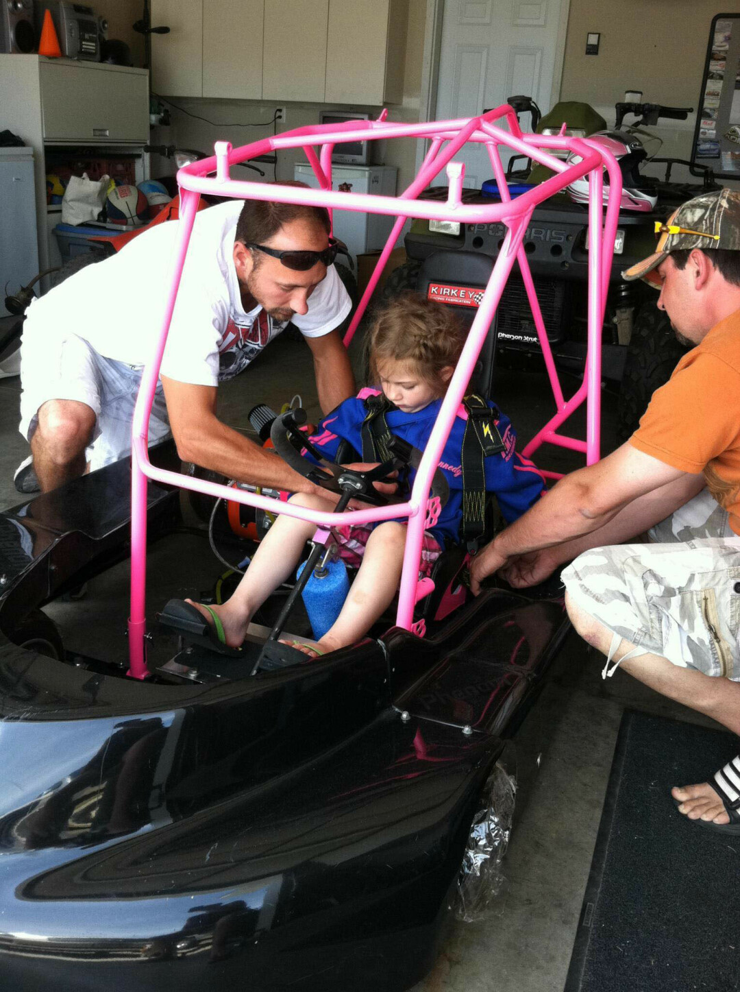 LITTLE GIRL, BIG DREAMS. 3-year-old Kennedy Swan gets geared up in her first race car. (Submitted photo)