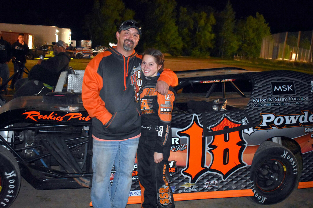 SIGNATURE COLORS. Kennedy Swan and her dad, Jason, now sport the signature orange color as a racer in her 18-S vehicle. (Submitted photo)