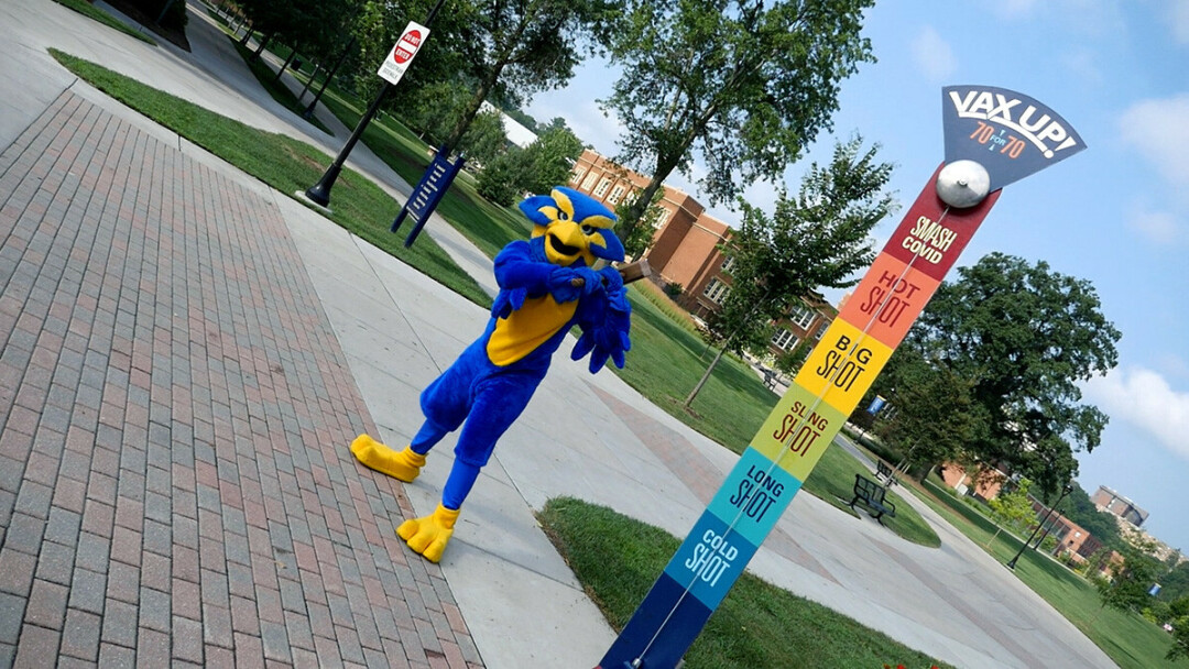 SMASHING SUCCESS. Blu, the UW-Eau Claire student body mascot, wields a hammer ready to smash a carnival-style game promoting a student vaccination campaign. (UWEC photo)