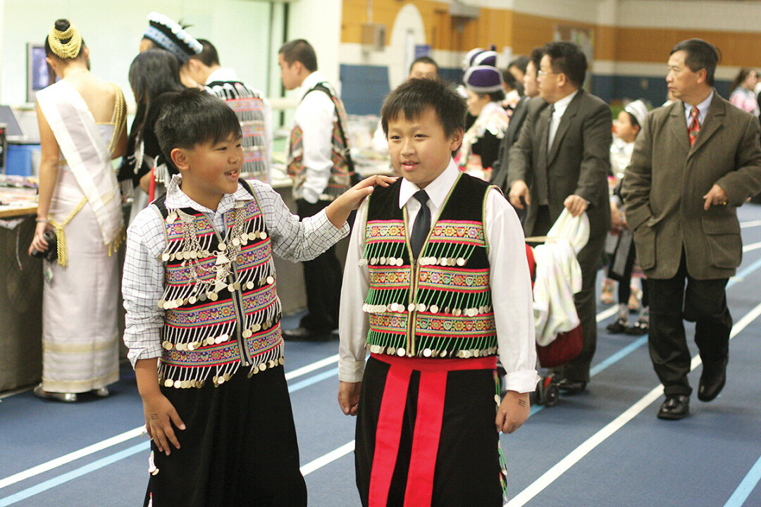 RICHLY DRESSED. Hmong New Year clothing is often adorned with coins for good fortune.