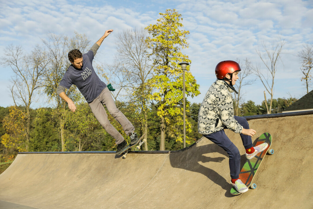 Gabe Brummett, pictured left, skateboards in Lakeshore Park in Eau Claire with his son, 