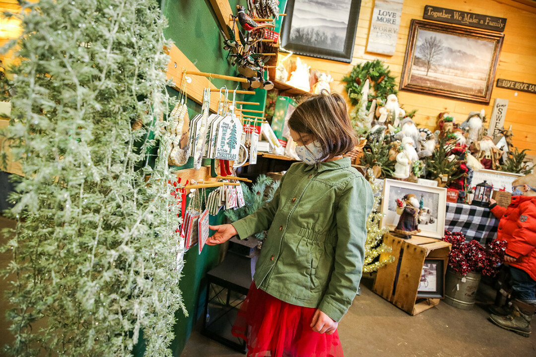 'TIS THE SEASON OF GIVING. During the holiday season, picking out gifts for the people we love – like this young shopper at Pleasant Valley Tree Farm – is one way of showing them how much we care.