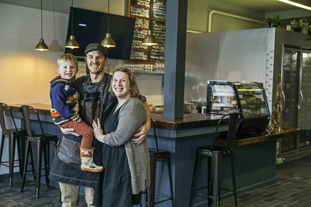 RAWRSOME NEW PLACE. Jared Bilhorn (left center) and Megan Knox (right) are the new owners of 3rd & Vine in Eau Claire, along with their four-year-old son Iver (left), who isn't quite old enough to enjoy beer at his parents' new shop, but he's totally cool with that, as he has lots of dinosaur toys to play with.