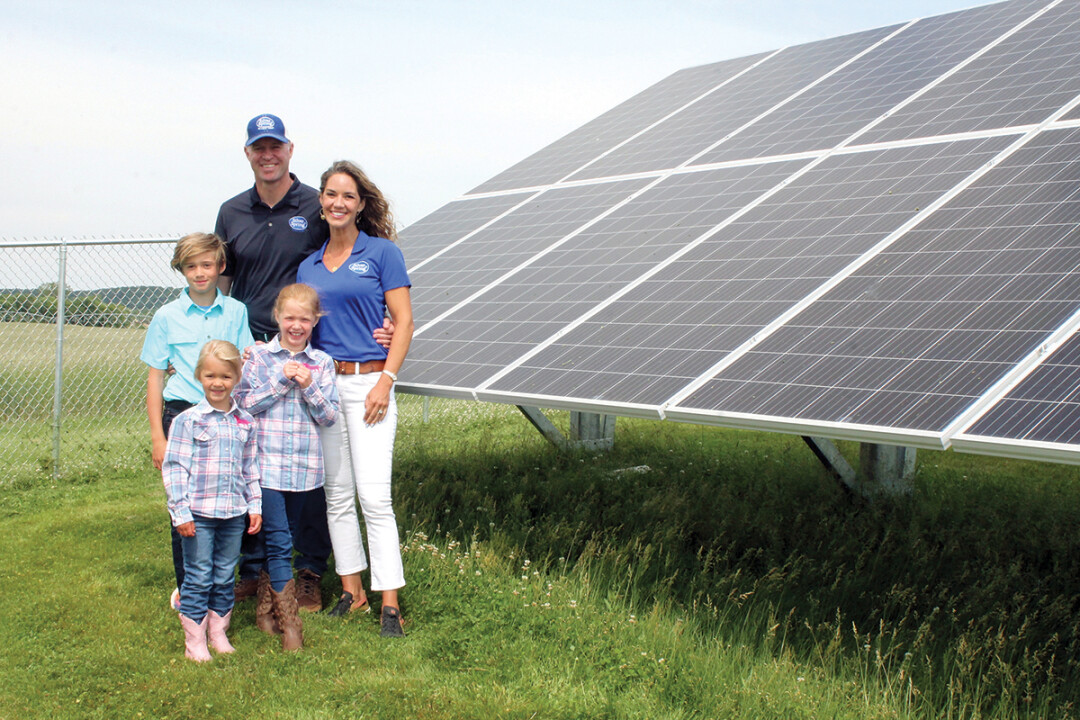 HERE COMES THE SUN. Eric Rygg, president of Silver Spring Foods, and his family are shown with solar panels 