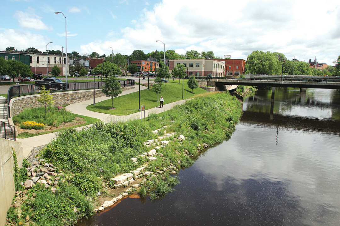 The Eau Claire River in downtown Eau Claire. A historic marker about Jonathan Carver's journey through what would become Eau Claire is memorialized on the historic marker along the footpath at the center of this image. (Photo by Andrea Paulseth)