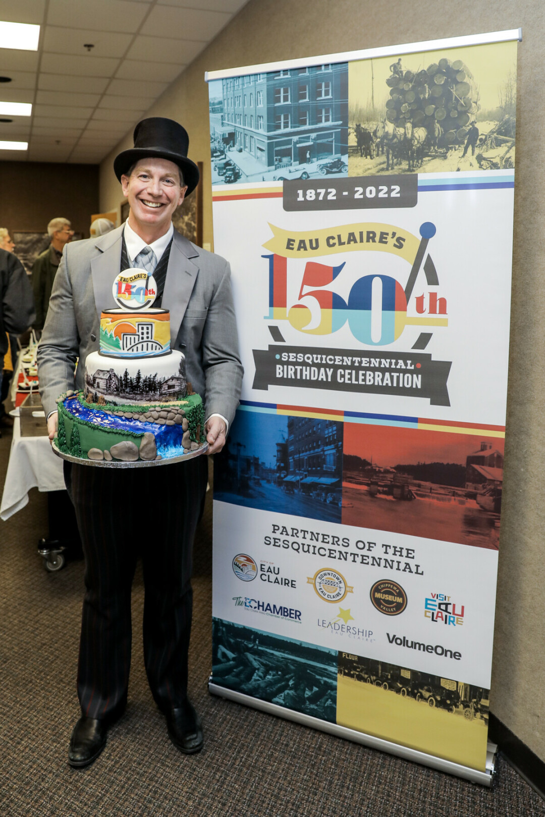 SESQUICENTENNIAL STYLE. Interim City Manager Dave Solberg poses with Eau Claire’s birthday cake.