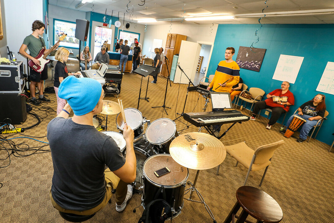 Musician Mike Rambo, foreground, lays down a beat during a jam session at the new home of CollECtive Arts in downtown Eau Claire.