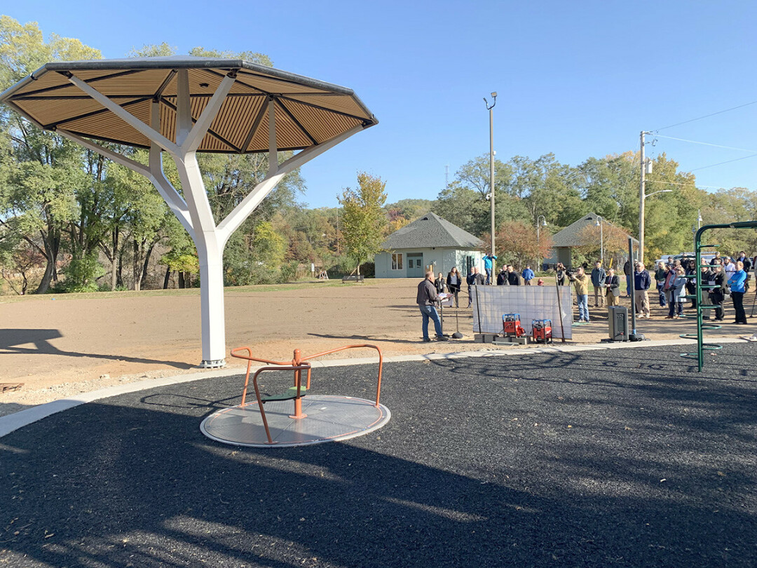 SUN SPOT. Brian Groff of Solar Forma Design speaks at a ceremony unveiling the new E-Cacia Solar Tree installed in Eau Claire's Boyd Park. (Photo by Jim McDougall)