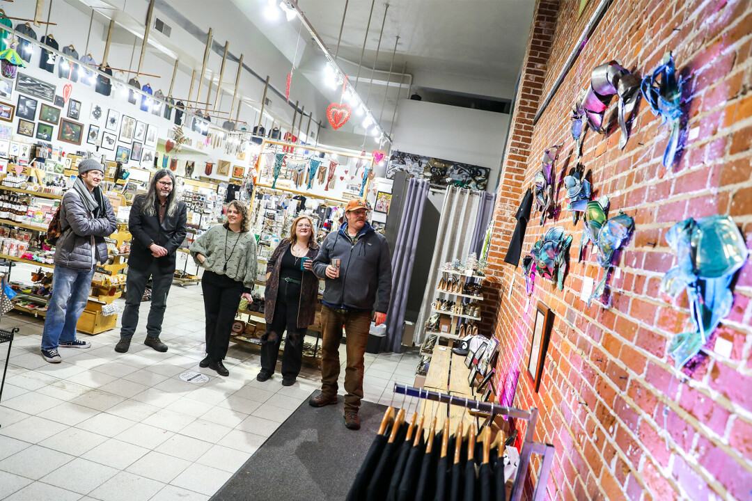 HAPPILY ENTANGLED. The longtime downtown Eau Claire arts shop, Tangled Up in Hue, threw a shindig for its 14th year celebration. Part of that shindig included local artist Steve Bateman who also lit up a special art installation.