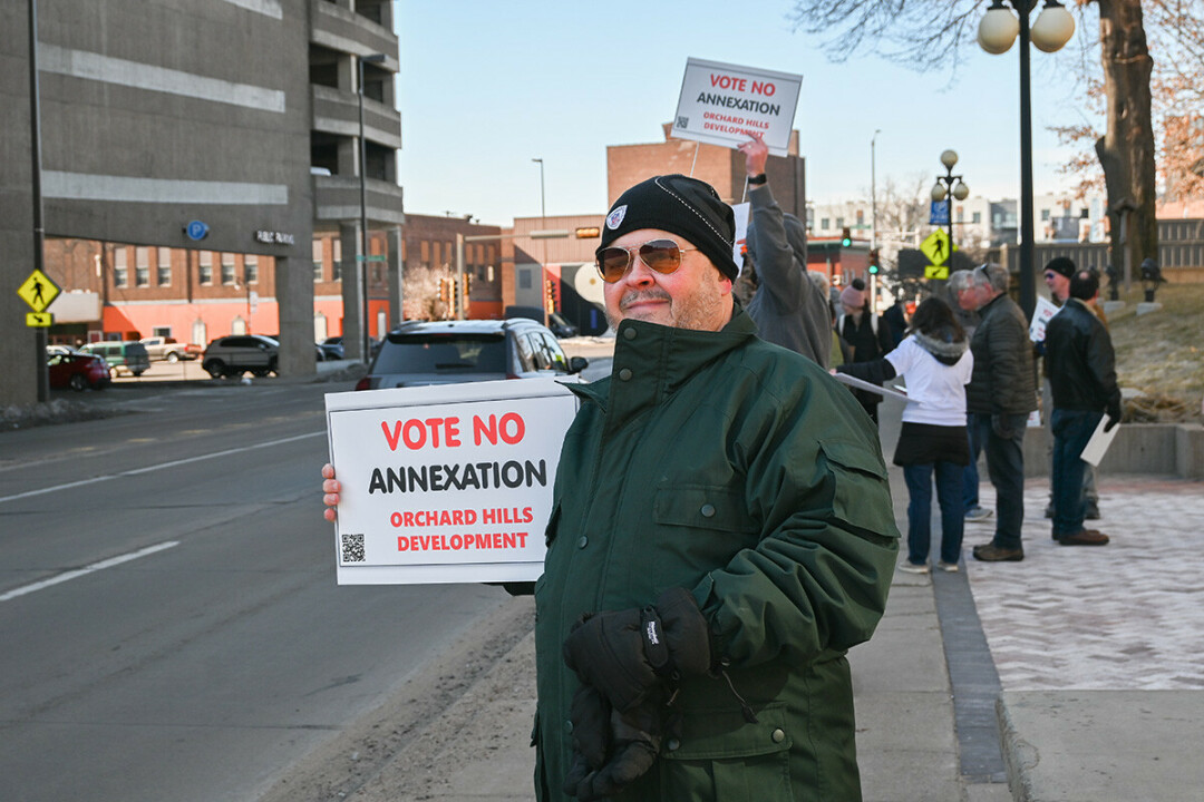 ANNEXATION CONVERSATION. Picketers opposed to the Orchard Hills annexation gathered outside Eau Claire City Hall before the March 28 Eau Claire City Council meeting.