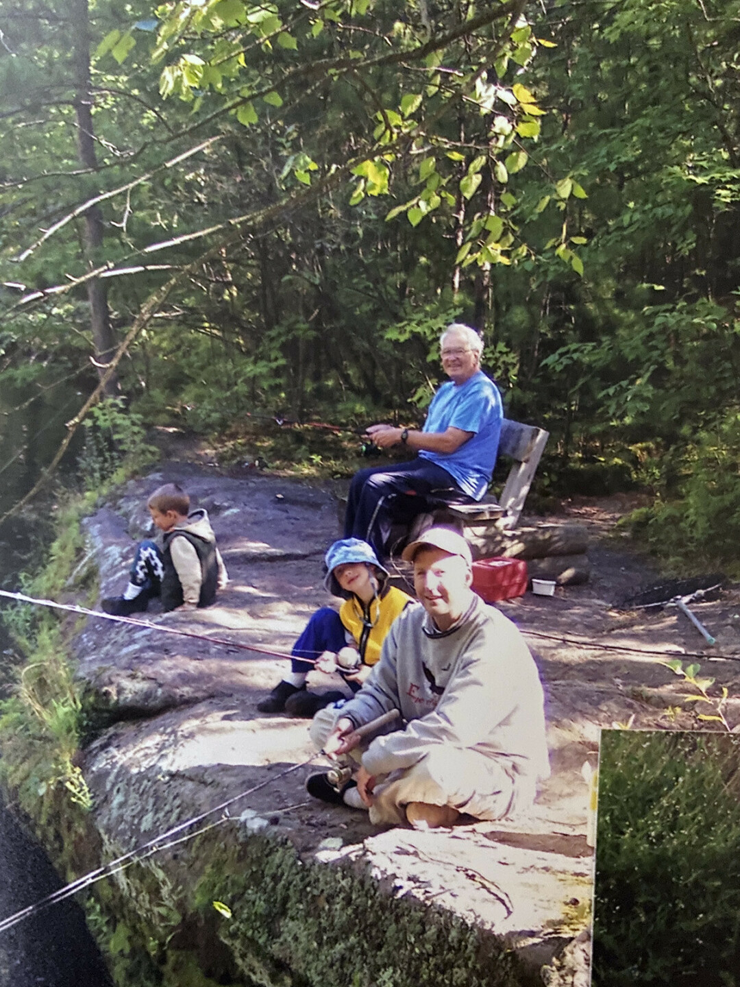 Orrin Rongstad, his son-in-law, and grandsons at the fishing hole in 2002. (Submitted photo)