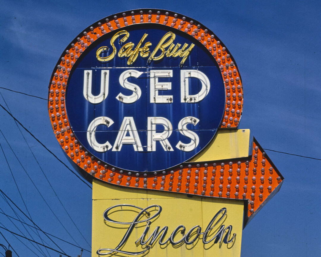 A sign at a used car lot in Quincy, Massachusetts, circa 1984. (Photo by John 