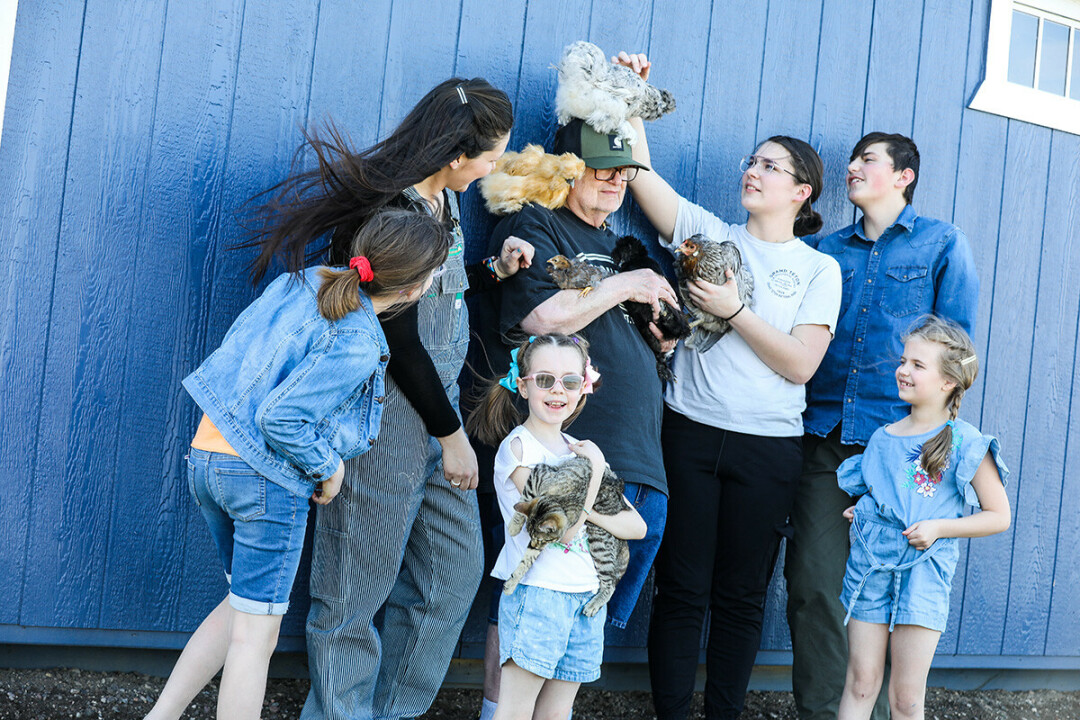 HOLD VERY STILL! Stephanie Bartholomew (second from left) and her children pose with some of the chickens from the family’s egg-selling operation, Happy Hatching. At center is her father-in-law, Pete, who gathers recycled packing material for shipping the eggs. Read more on page 17. 
