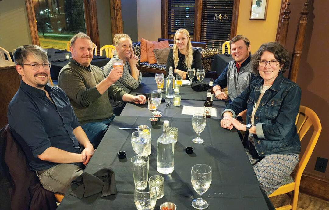 CHEERS TO COOPERATION: Chris Gregory and Lesley Blaine, second and third from left, discuss supply chain issues in Chippewa Falls.