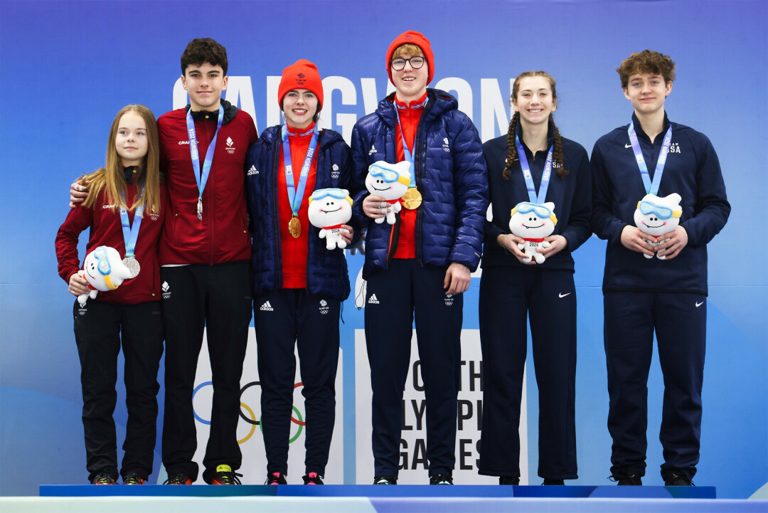STANDING TALL. Eau Claire native Benji Paral and mixed doubles partner Ella Wendling, Wausau (right), officially took the medal stand for Team USA at the 2024 Winter Youth Olympic Games. (Photo via World Curling)