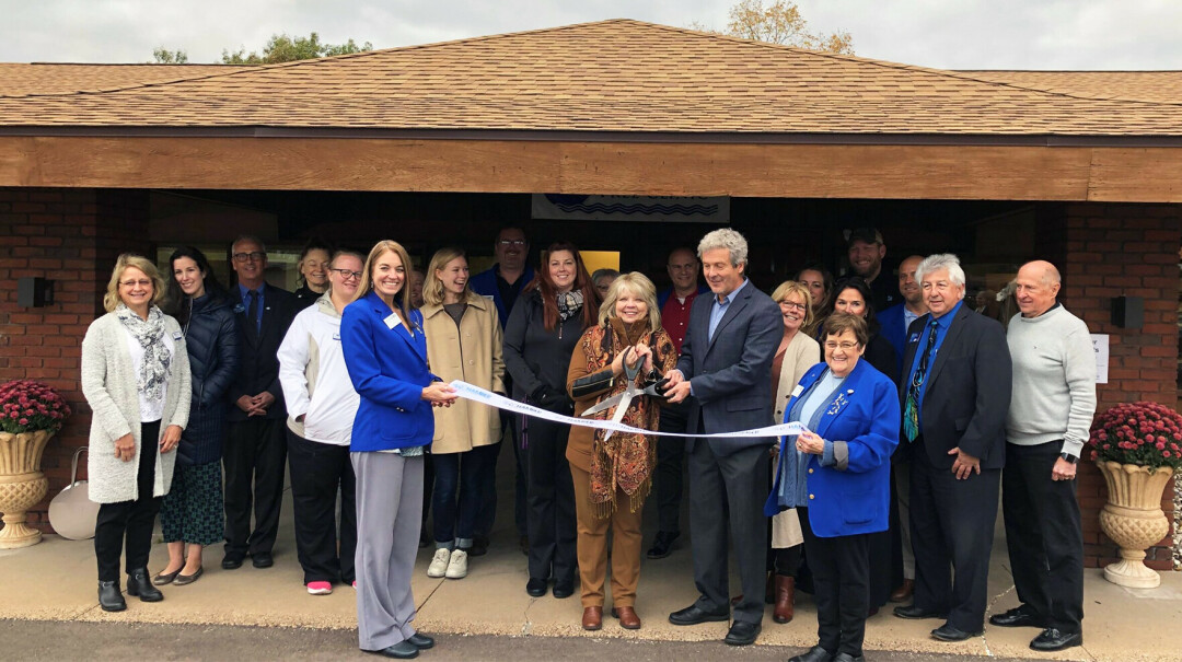 PASSING THE TORCH. After joining the Chippewa Valley Free Clinic as Executive Director in 2011, Maribeth Woodford is officially retiring at the end of June. Pictured is Woodford, center, at the ribbon cutting for the clinic's current location in Eau Claire.