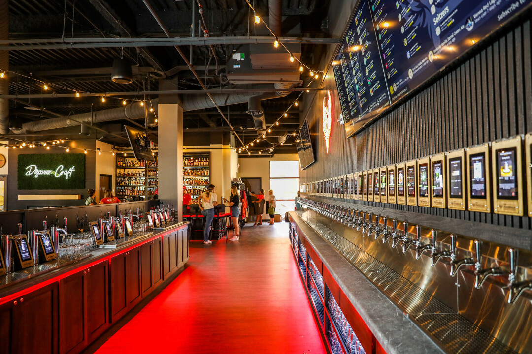TAPPED OUT. The Phoenix Taproom & Kitchen boasts 70+ taps, an elevated appetizer menu, patio-in-progress with a riverfront view, and title: The biggest self-pour taproom in the Midwest.