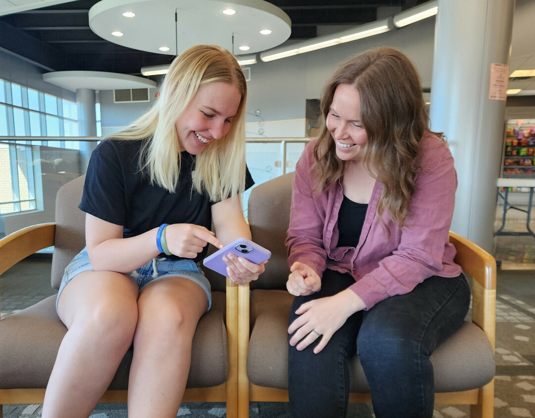 COMMUNITY EFFORT. Karly Kibbel, left, and Jordy Miles, nursing students at CVTC, discuss the resource guide they created for the Aging & Disability Resource Center of Eau Claire County. (Submitted)