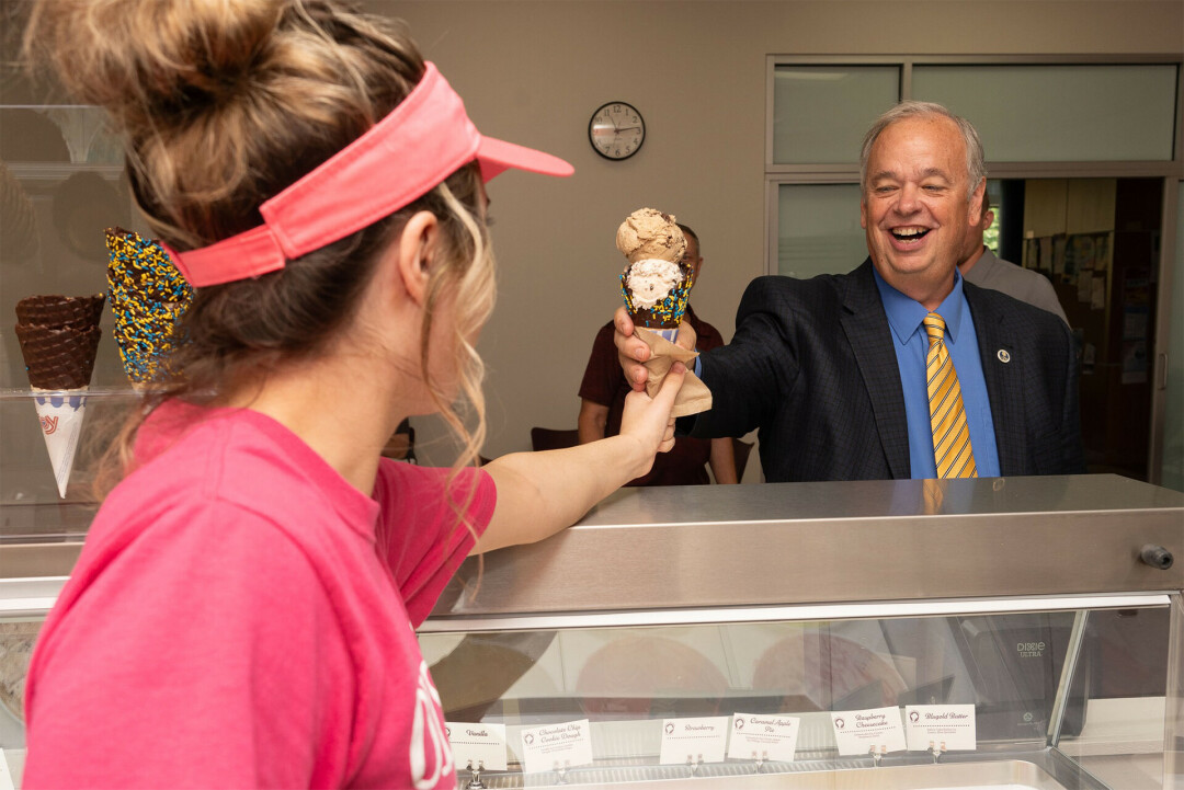 SCOOPS FOR STUDENTS. UW-Eau Claire recently added a new dining option for its students on campus: Olson's Ice Cream. Chancellor Jim Schmidt pictured getting a cone. (Photos via UWEC)