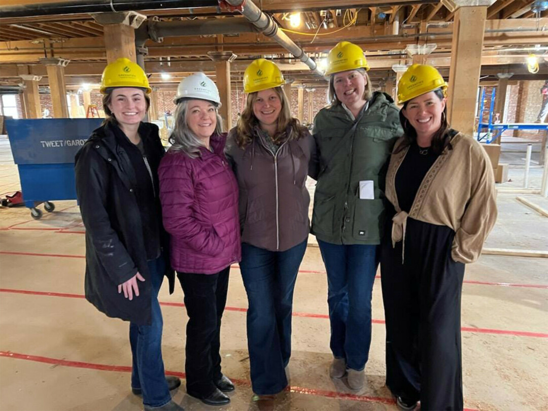 Boos, far right, during a February 2024 walk-through of Market on River during construction.