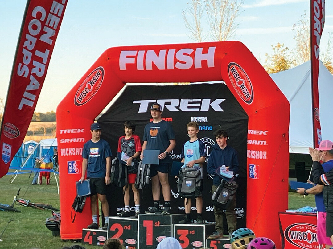 TOPS ON THE TRAILS. Ryan Semerad, center, accepted his award as the top