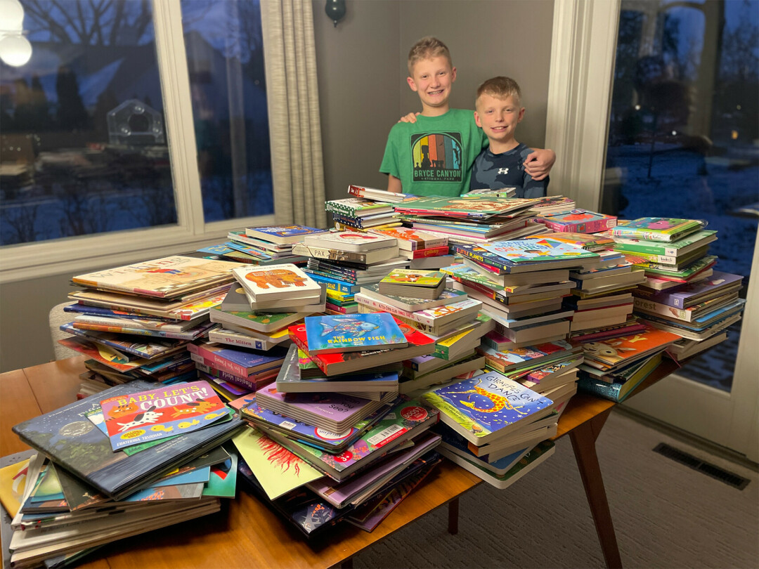 GIVING BACK IN A BIG WAY. Marshall and Miles Meeks, pictured, donated 430 books to the Eau Claire Give a Kid a Book program this year. (Submitted photos)