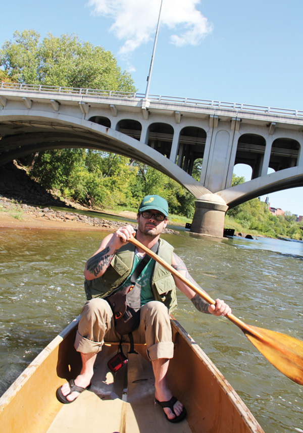WHATCHYA DOING THERE, BUDDY? PADDLING?  On the Eau Claire River between Dewey and Barstow Streets. That’s the Dewey Street bridge with Banbury Place in the distance.