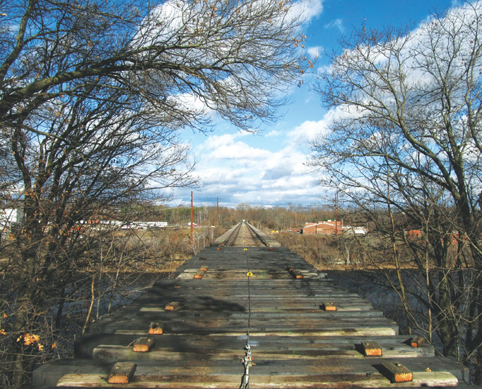 The city has begun work repairing and converting the “High Bridge” over the Chippewa River into part of Eau Claire’s trail system. Sometime this summer, the formerly unused railroad bridge will connect the city’s west side to the downtown area. Photo by Tina Ecker Photography.