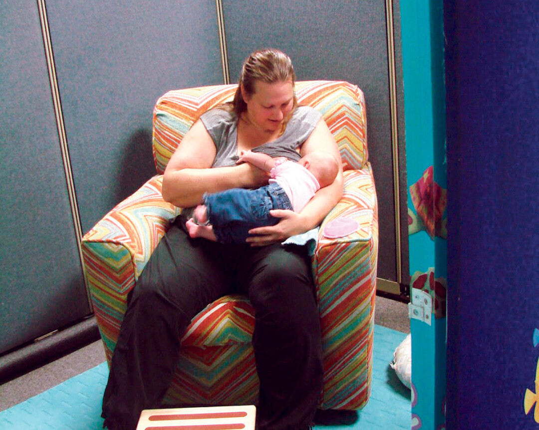 A MOTHER AND HER INFANT TAKE ADVANTAGE OF THE NEW NURSING NOOK AT THE FAMILY RESOURCE CENTER INSIDE EAU CLAIRE’S OAKWOOD MALL.