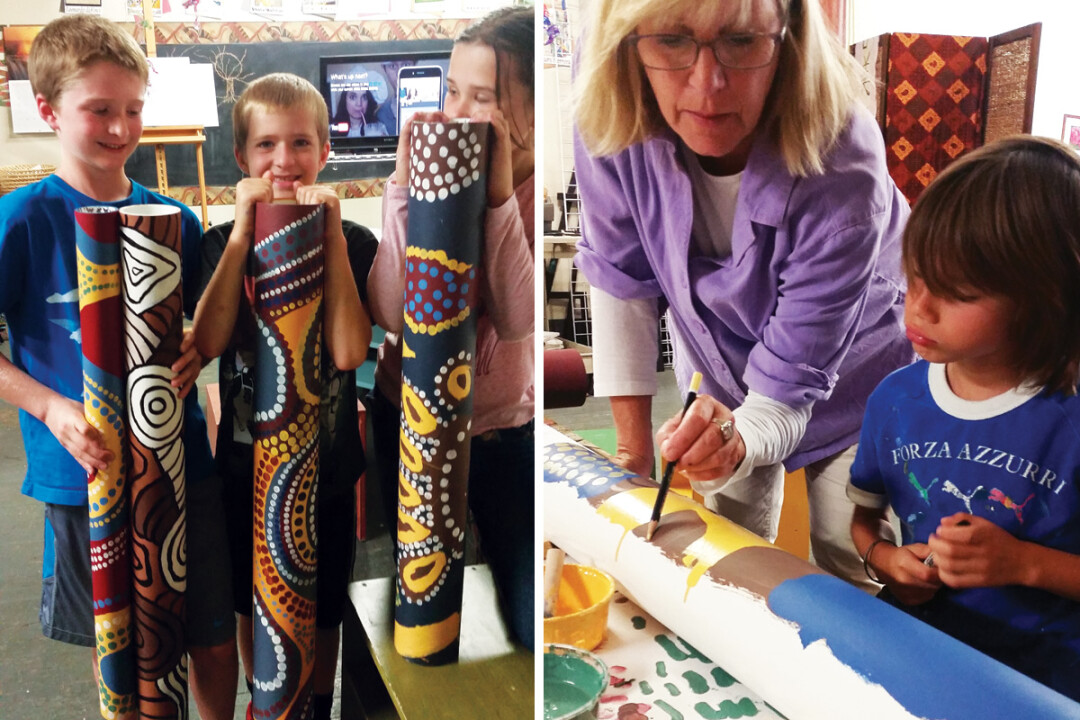 Students (left) show off some of their work for &ldquo;Sister City Study,&rdquo; and Jo Burke (right) helps a student. The work is inspired by aboriginal art found near Eau Claire's Australian Sister City, Lismore.