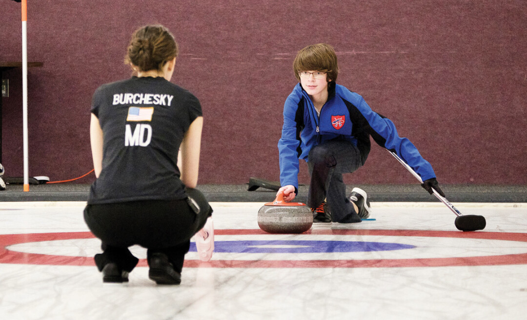 Charlie Thompson, 13, works with coach Jenna Burchesky at the Eau Claire curling club.  Thompson has been part of the junior curling program for five years and Burchesky, a freshman at UWEC, is new to the program after moving to Eau Claire from Boston.