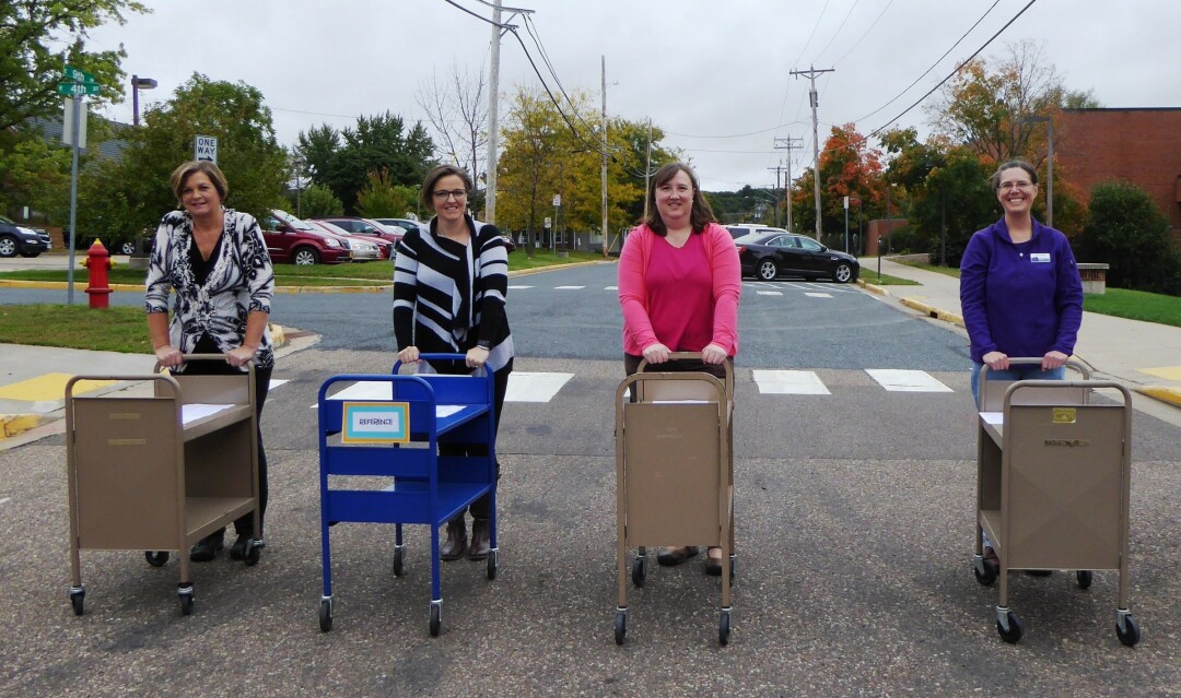 The University Library book cart drill team will perform in the UW-Stout homecoming parade Oct. 8 in Menomonie. The drill team will execute synchronized maneuvers while wheeling book carts along the parade route. Members are, from left, Robin Sweeny, Elizabeth Steans, Gretchen Yonko and Ann Vogl.