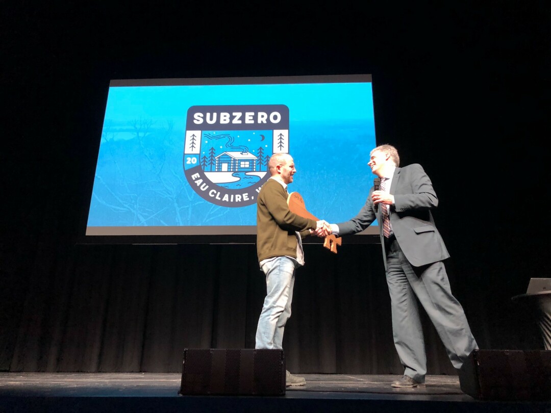 January 15, on stage in the RCU Theater at the Pablo Center on the Confluence: Jamf Software CEO Dean Hager (left), Eau Claire City Manager Dale Peters (center, holding key to city), and Jamf's Jason Wudi (right).